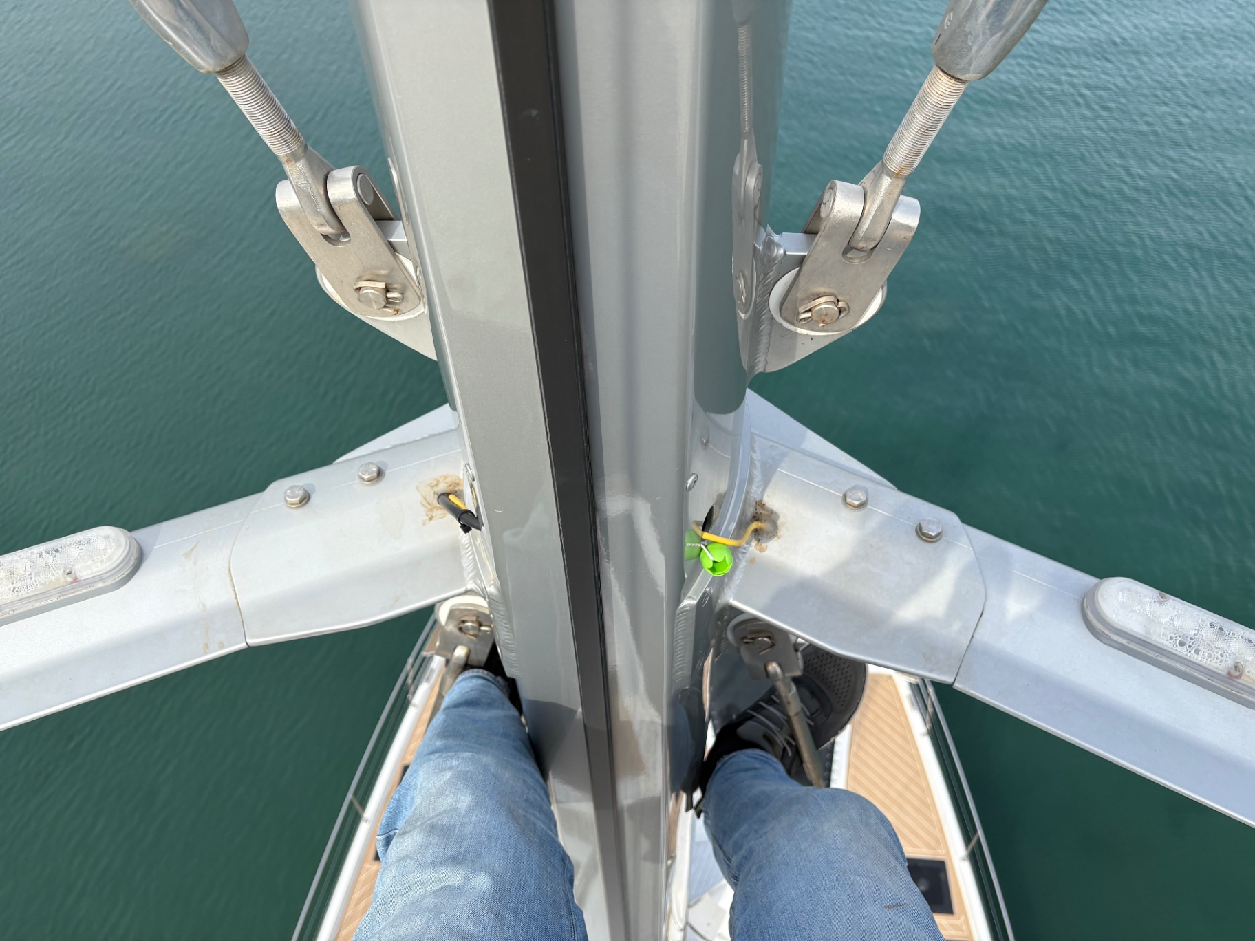 Masthead inspection looking down the mast at spreaders and tangs