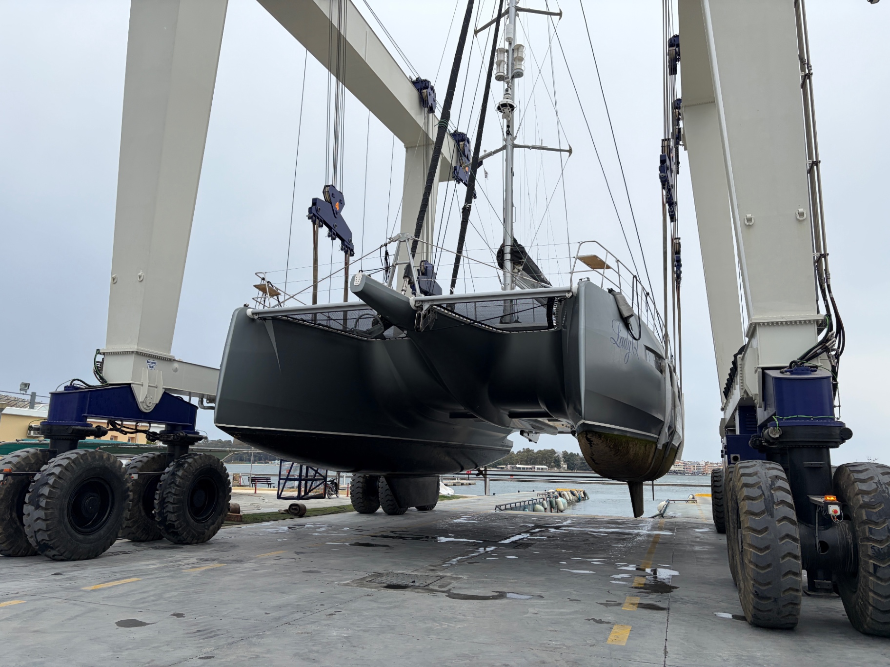 Performance sailing yacht in the travel-hoist during out-of-water survey