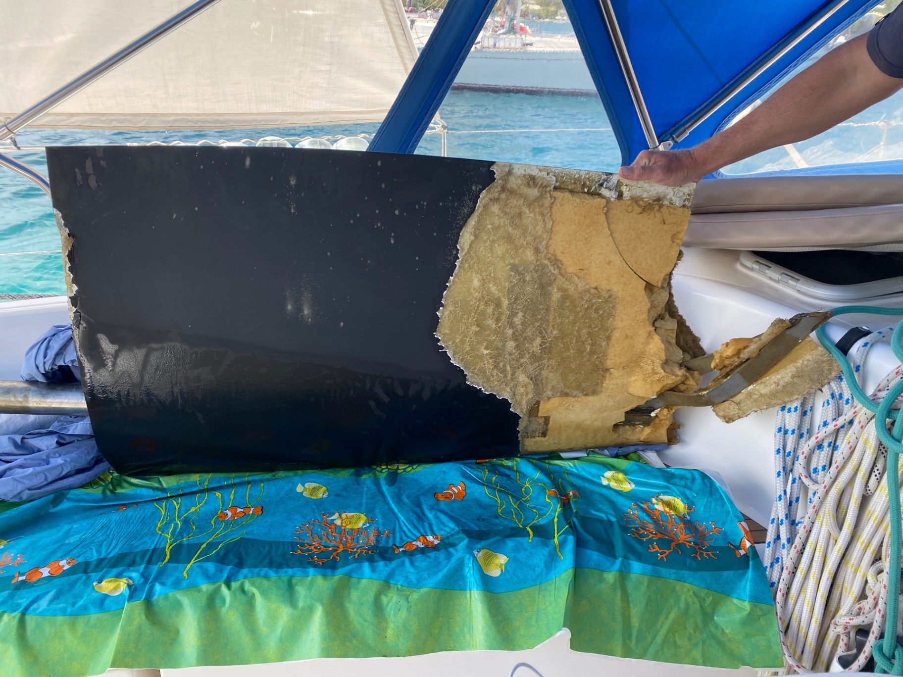 Damage survey — delaminated GRP panel revealing core failure