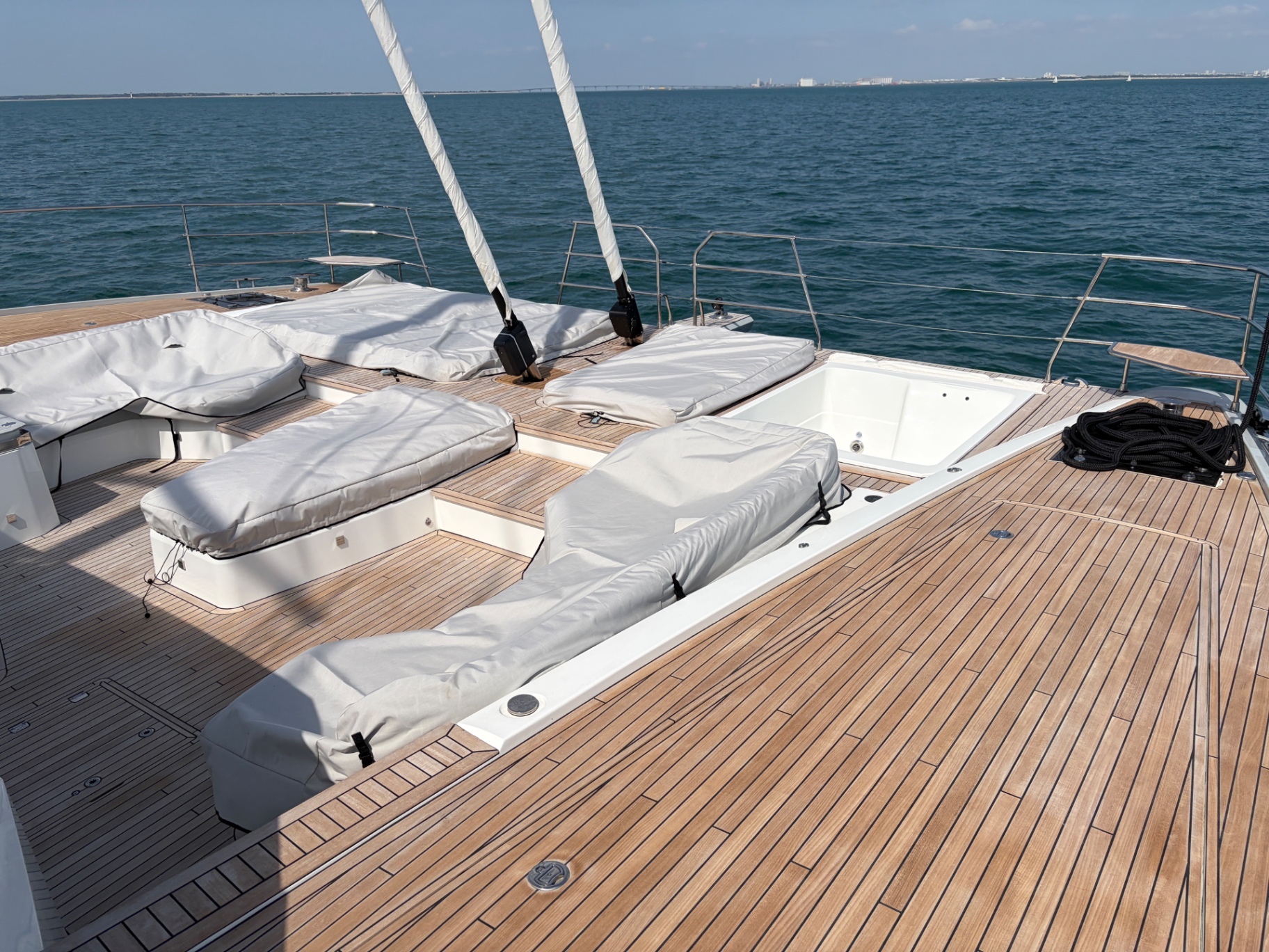 Sailing yacht foredeck with teak, sun loungers and jacuzzi
