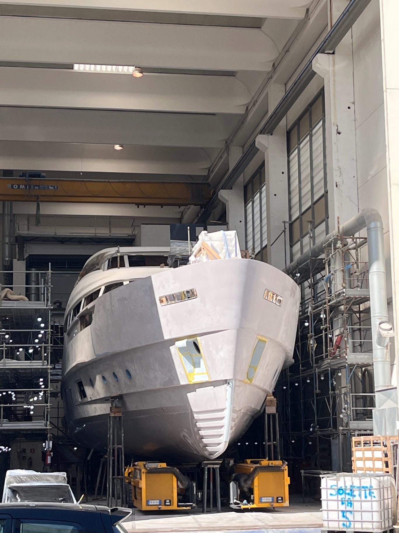 Motor yacht hull in build hall during owner's surveyor visit