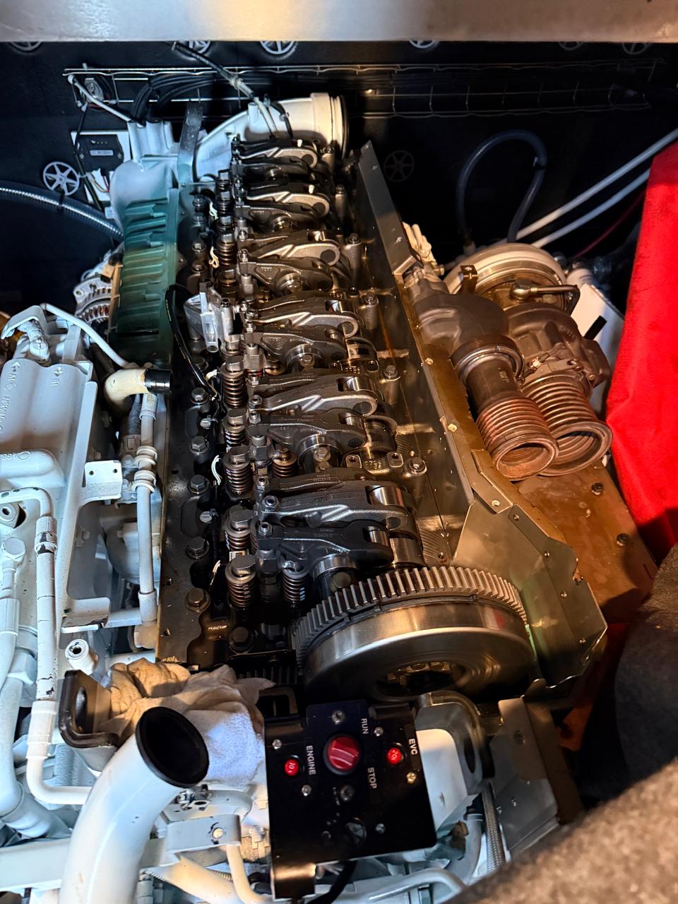 Six-cylinder marine diesel with rocker cover removed for valve-train inspection