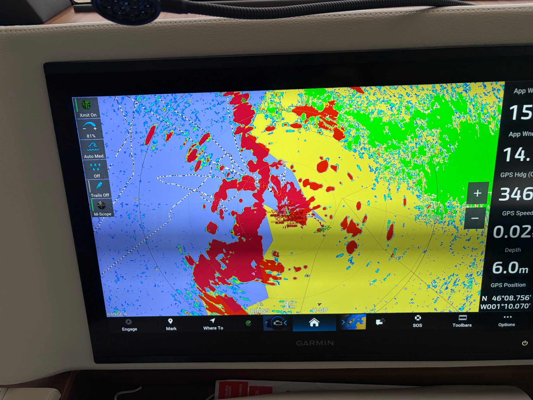 Garmin chartplotter with radar overlay showing approach to harbour